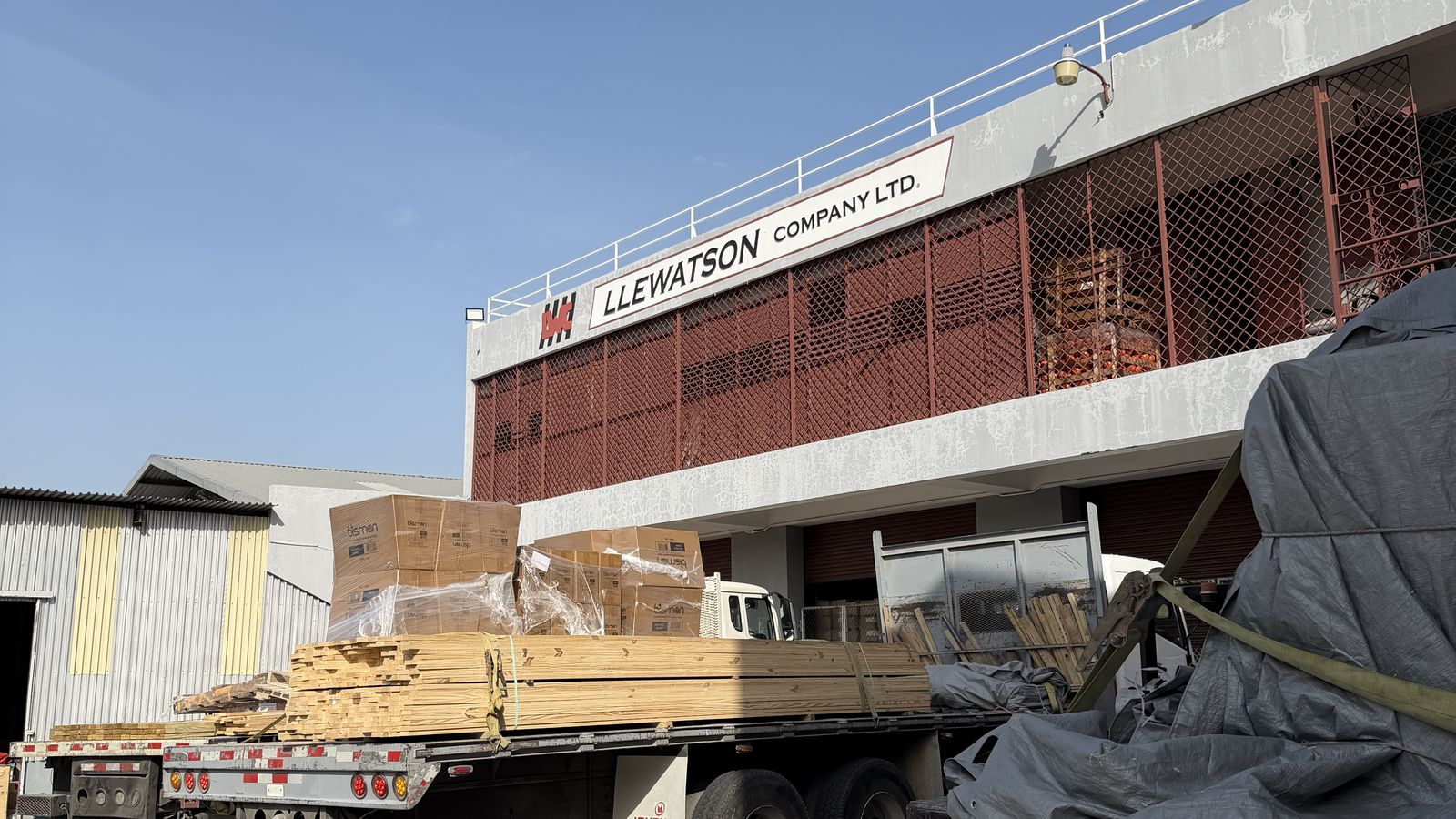 Trucks loaded with lumber and boxed goods at the head office loading bay